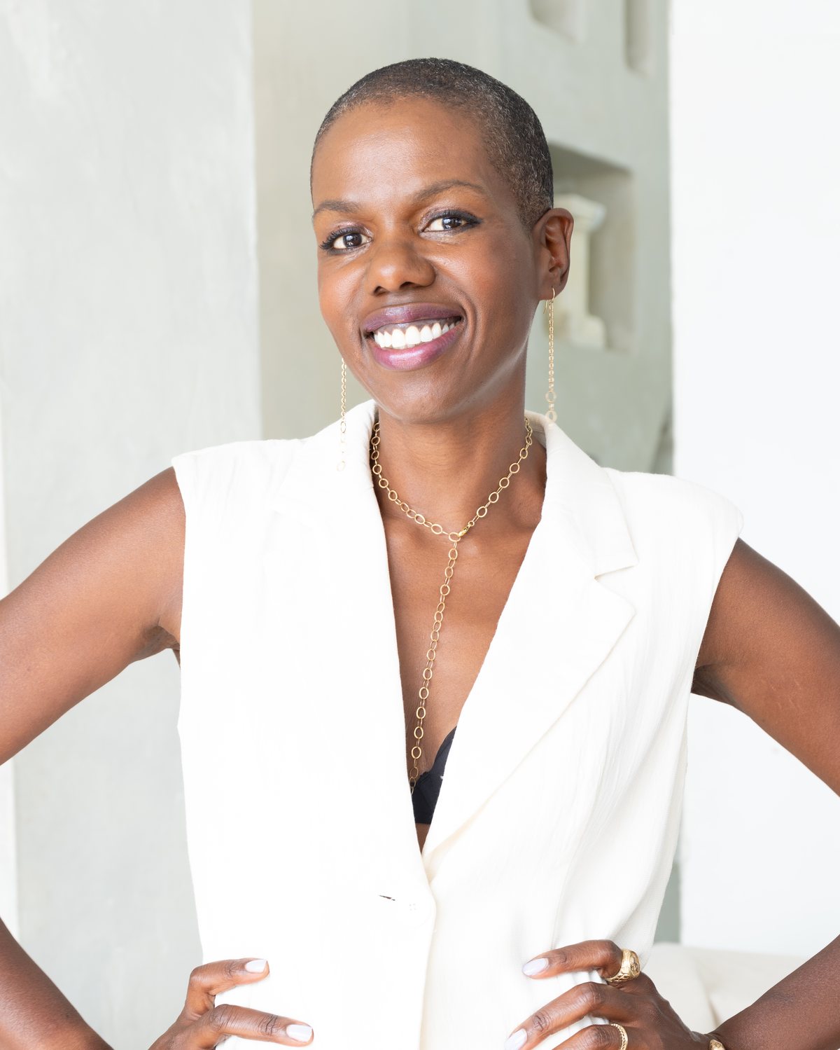 Francesca Hogi, love and life coach, photographed against a plaster arch