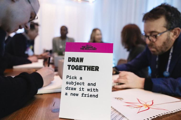 A TED discovery session table card reading Draw Together: pick a subject and draw it with a new friend